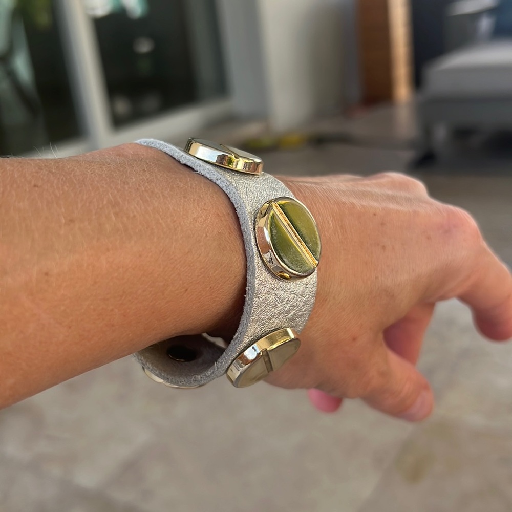 Bracelet, silver white imitation leather and gold tone.